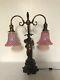 Ornate Vintage Figural Cherub Table Lamp With Cranberry Swirl Glass Shades