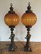 Pair Of Vintage Bronze Metal Cherub Figural Lamps Amber Glass Shades Globes Mcm